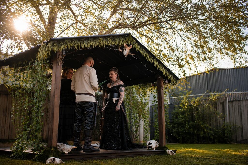 Pagan wedding ceremony Melbourne celebrant officiating outdoor gothic-themed ceremony